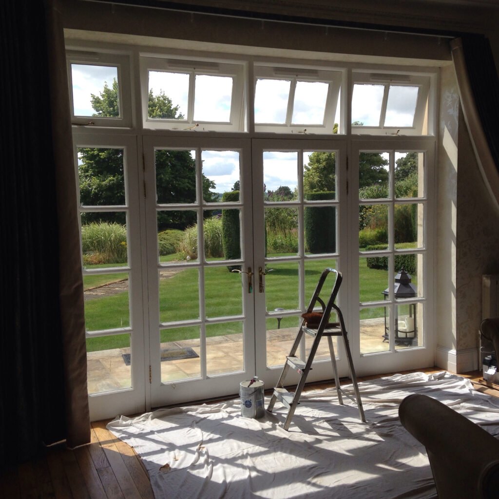 Restored French doors and fanlight windows on period manor house in Addington Buckinghamshire