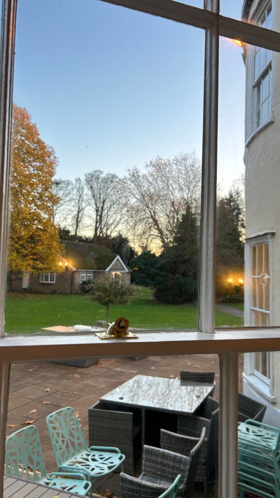Restored period sash window at Woodland Manor Hotel showing garden views in Bedfordshire