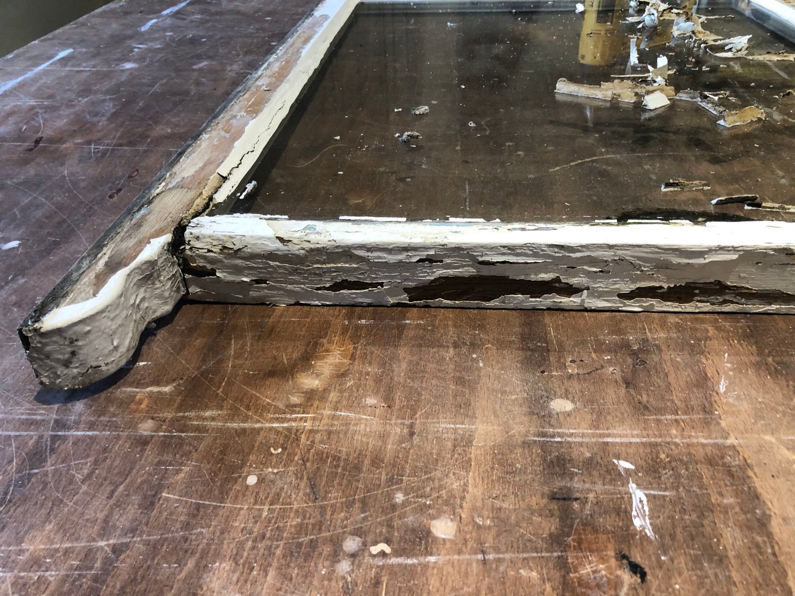 Severe rot damage on Victorian sash window bottom rail before restoration in Stoney Stratford