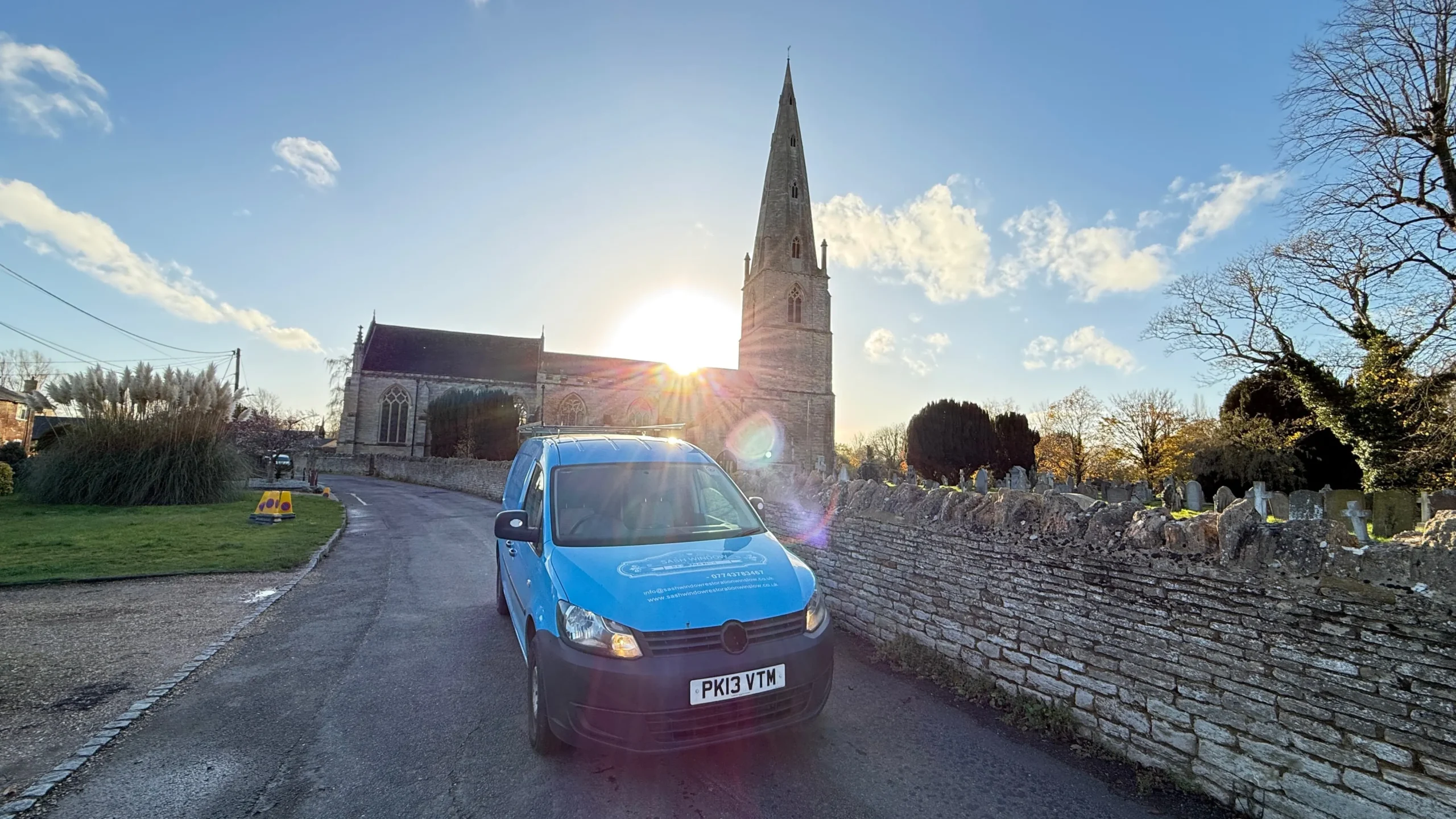 Sash Window Restoration Olney survey van parked outside St Peter and St Paul's Church.